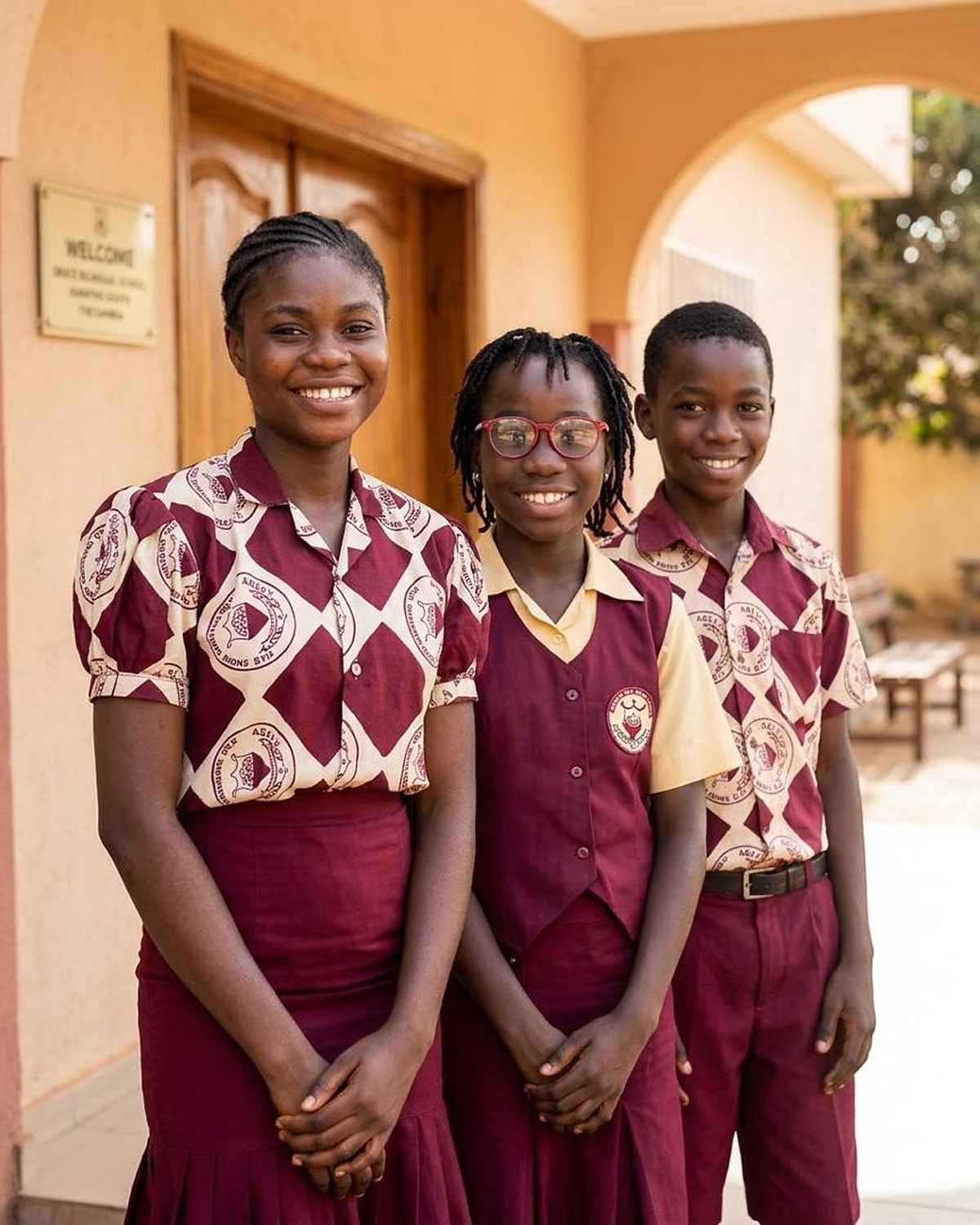Smiling pupils in uniform at the school entrance